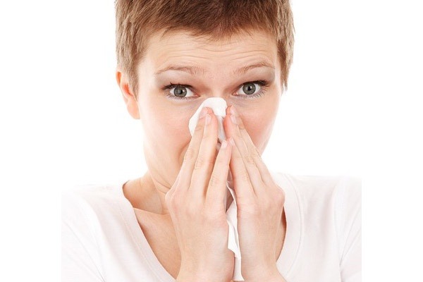 Health-conscious environment emphasized in a coworking space, as an individual practices hygiene, underscoring the commitment to wellness in shared legal offices.