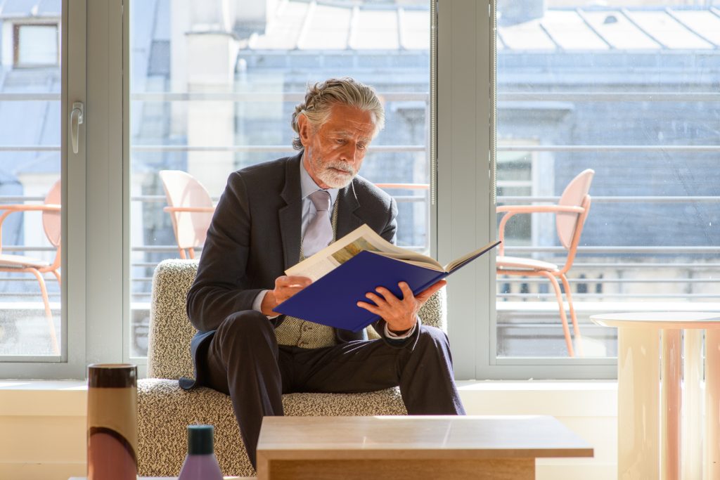 A senior businessman consults a file