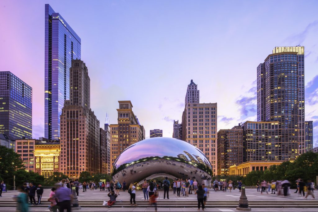 "The Bean", in a summer night with tourists visiting a Chicago Business Address.