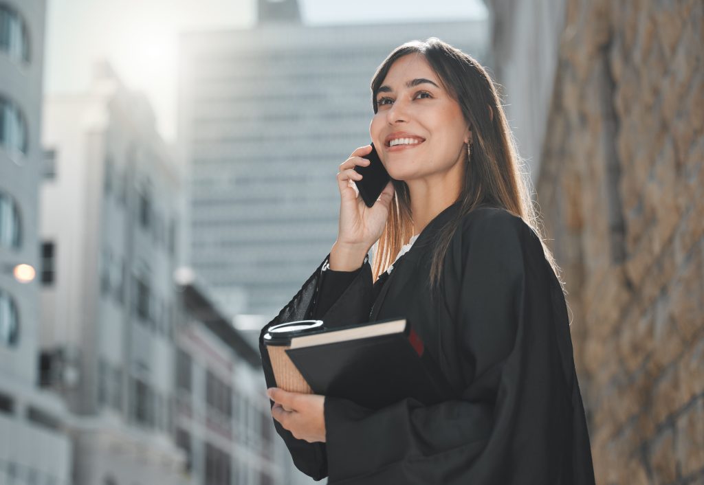 Lawyer, woman and phone call with smile in street for law, justice or human rights with advice for job at court. Attorney, advocate and person with book, contact or documentation for evidence in chicago offices